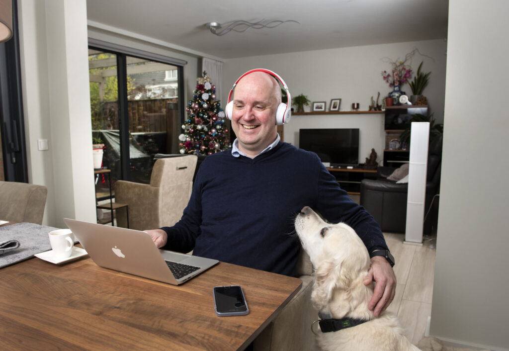 Foto van Rik zittend aan een tafel samen met zijn hond River